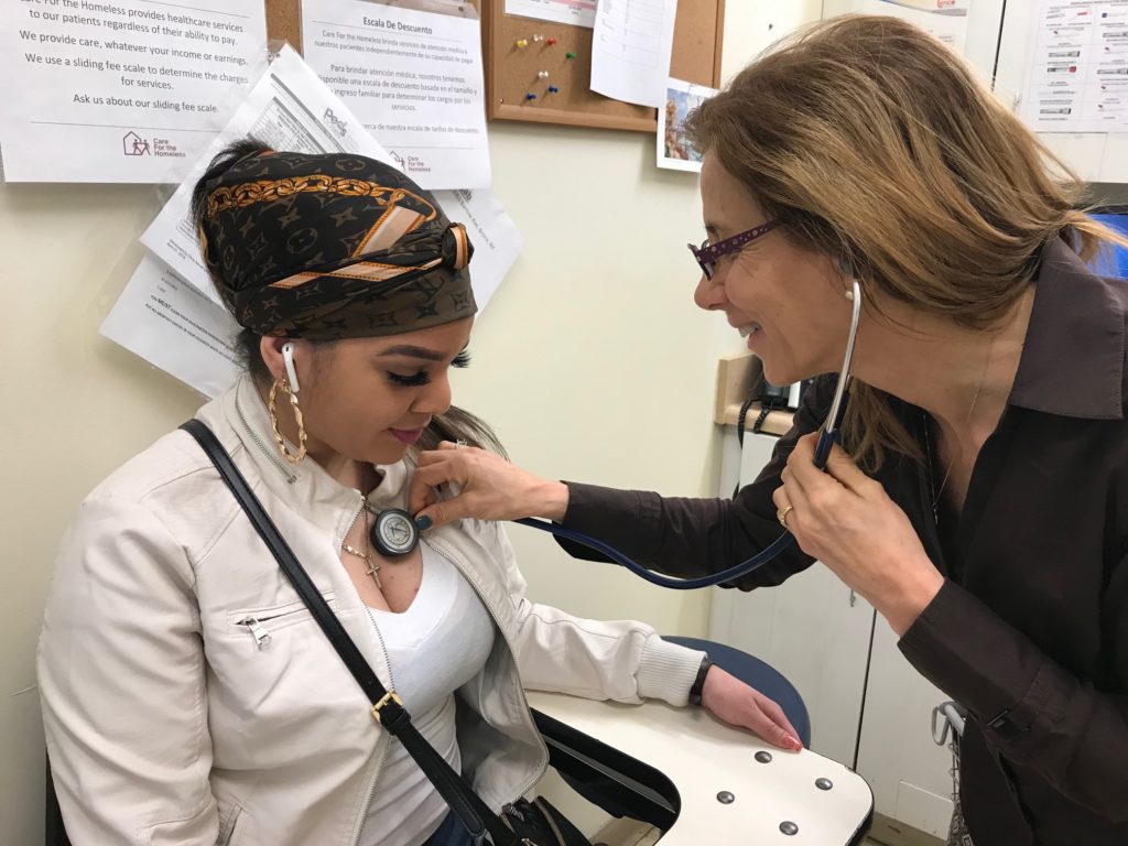 Joy checking a patient's heart rate.