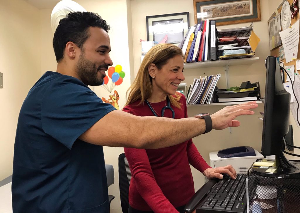 Joy and her assistant, Orlando Canales, checking the schedule.